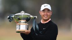 Tom Kim poses with the Genesis Scottish Open trophy following his win in 2026