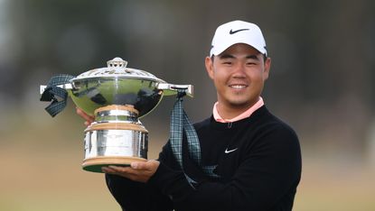 Tom Kim poses with the Genesis Scottish Open trophy following his win in 2026