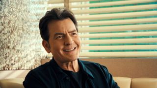 Charlie Sheen seated at a diner booth in the Netflix documentary "aka Charlie Sheen"