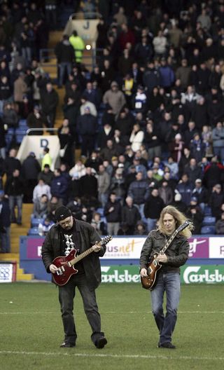 Doug Scarratt and Paul Quinn play to the crowd during the bands Guinness World Record attempt for playing air guitar at Hillsborough Stadium