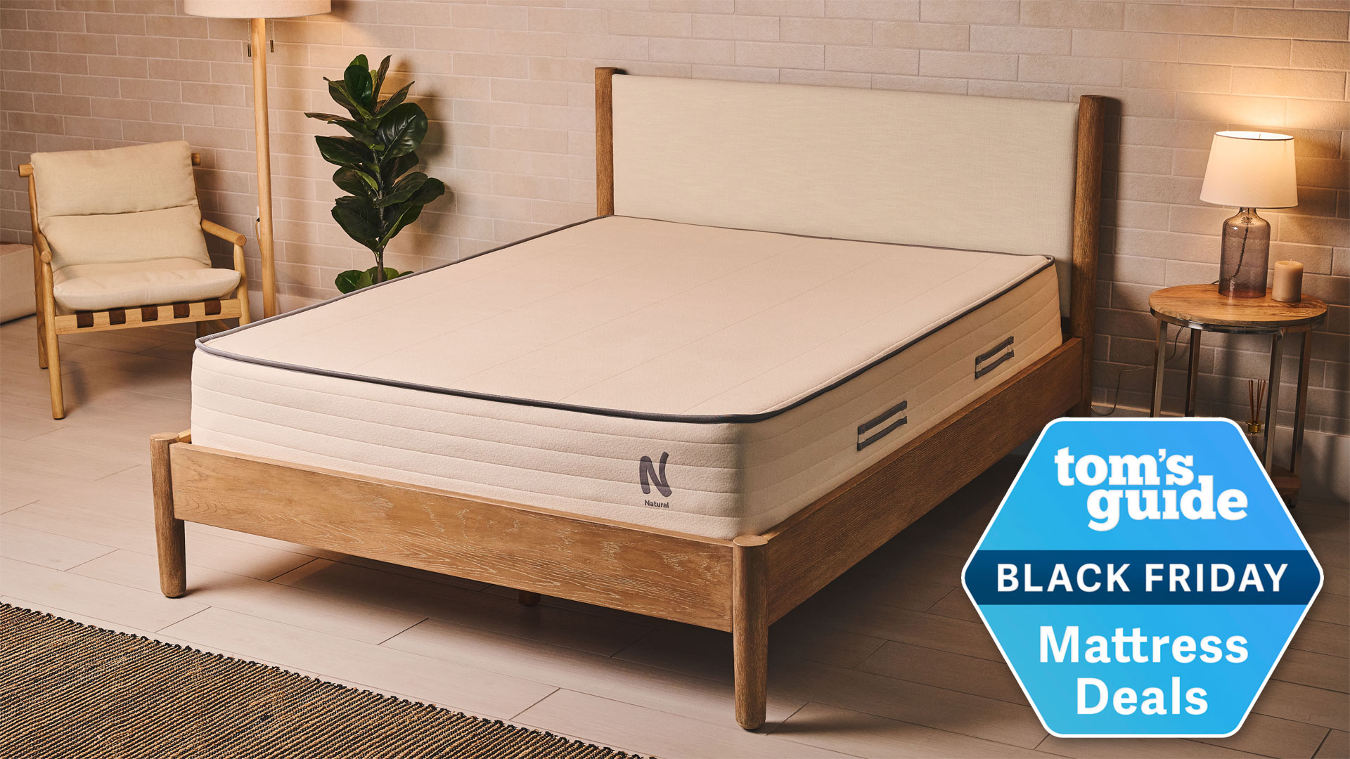 The Nolah Natural 11 Mattress in a well-lit bedroom with a Tom&#039;s Guide Black Friday Mattress Deals badge overlaid