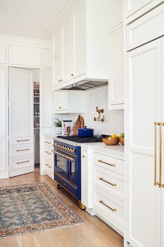 blue and white kitchen with hidden pantry