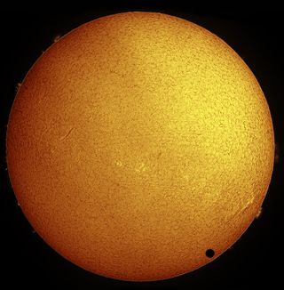 Paul Hyndman captured this stunning view of Venus crossing the face of the sun in hydrogen-alpha light on the morning of June 8, 2004 from Roxbury, Connecticut. He used an Astro-Physics 105-millimeter Traveler telescope fitted with a Coronado Solarmax90/T