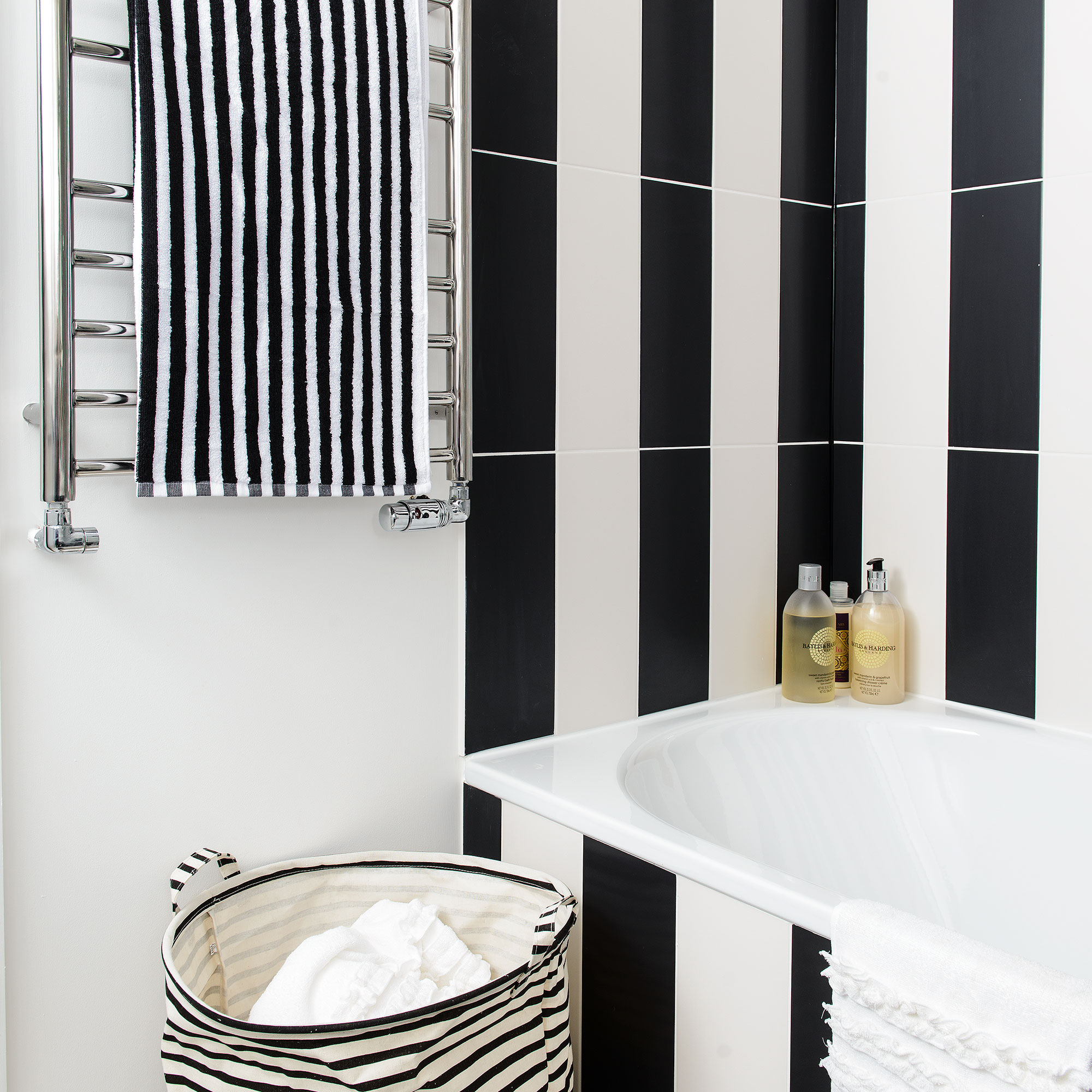 Bathroom with vertical black and white tile stripes