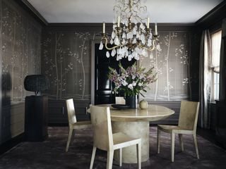 marble oval dining table in dining room with botanical print wallpaper by Jessica Lagrange
