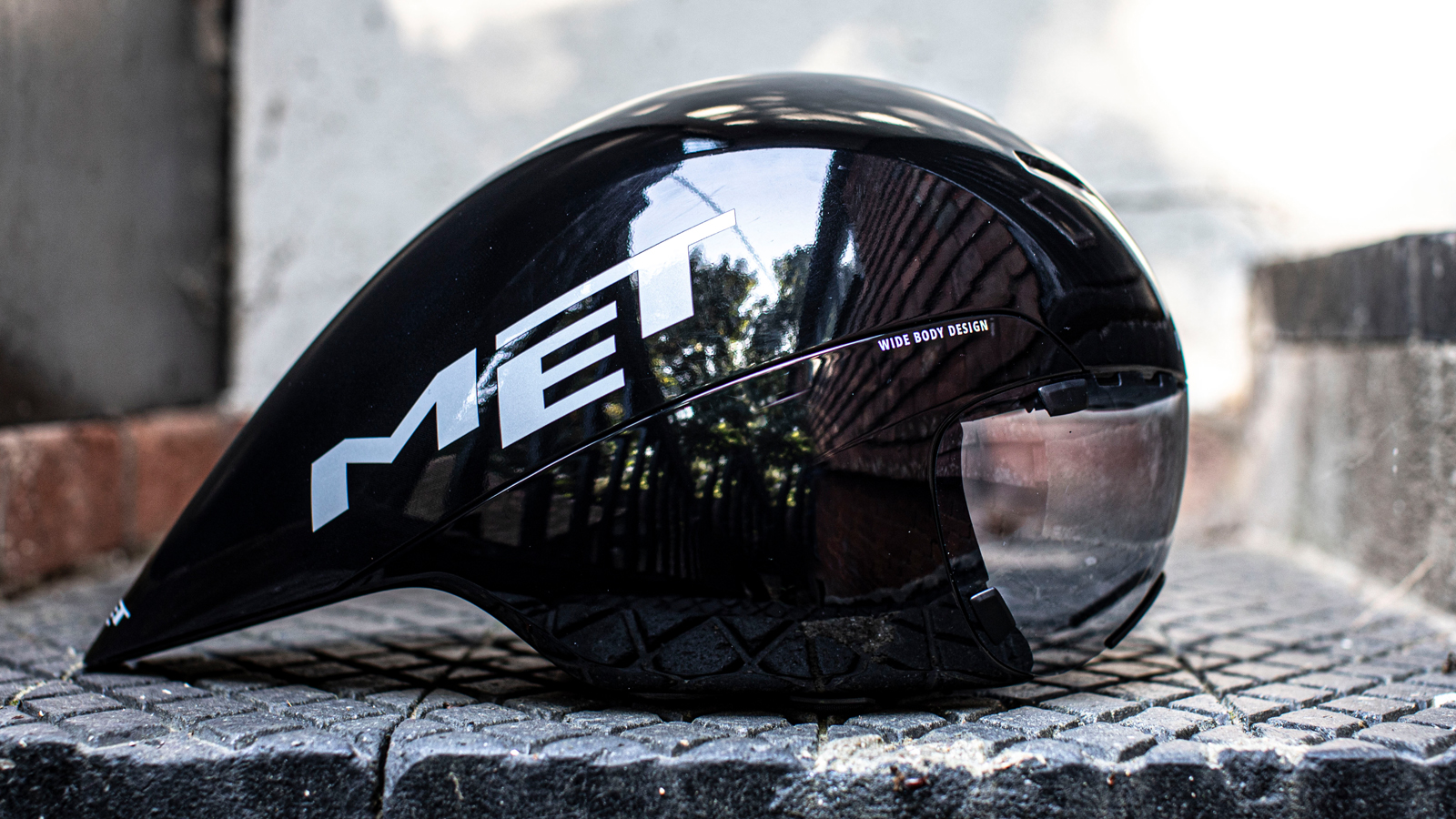 Met Drone Wide Body II helmet set upon a tiled floor