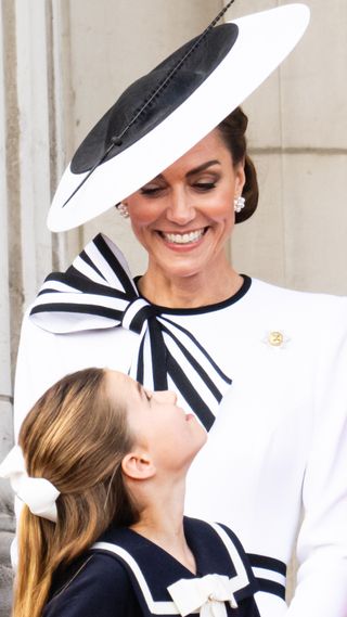 Catherine, Princess of Wales and Princess Charlotte look at each other during Trooping the Colour on June 15, 2024