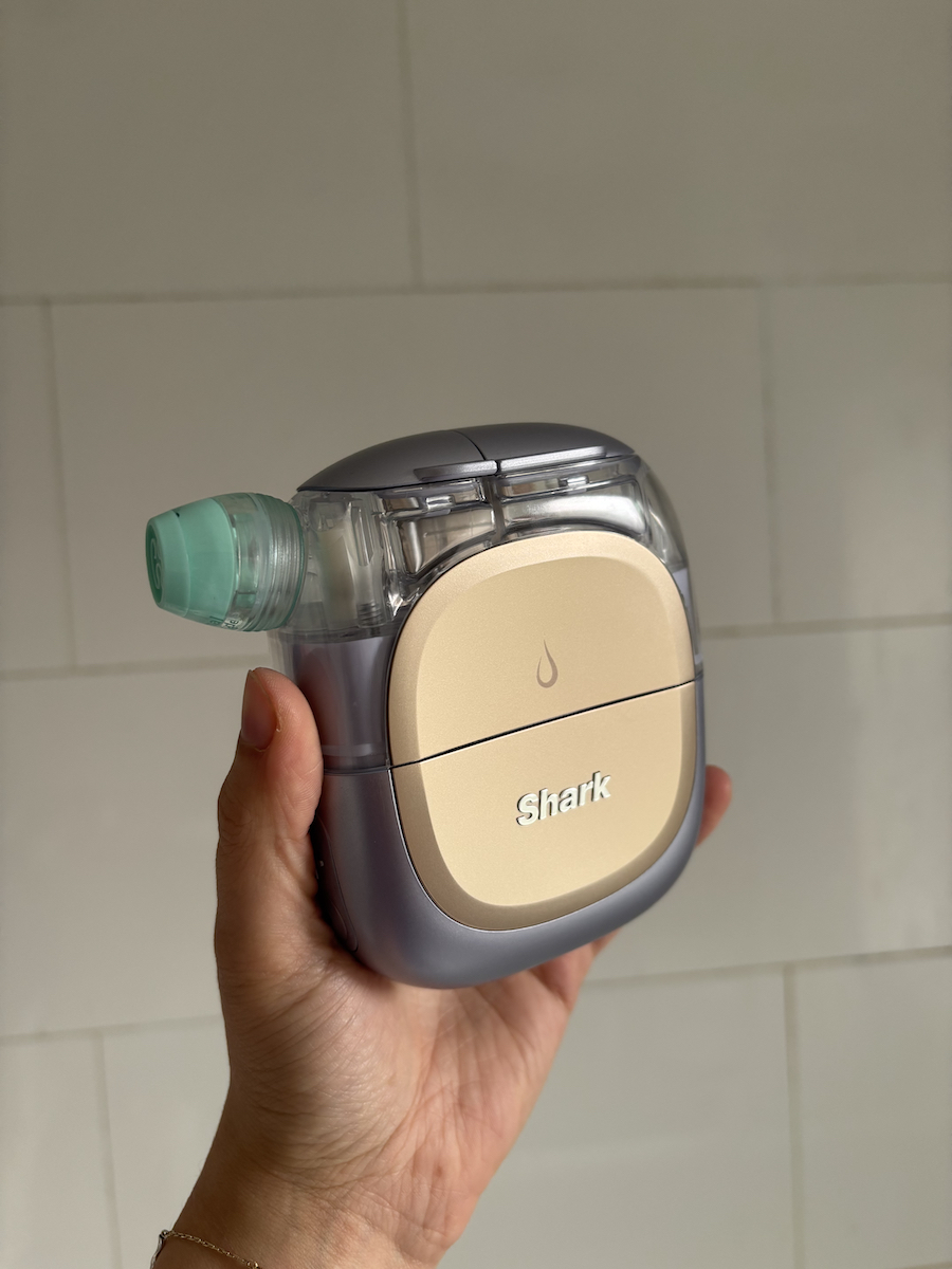 Mica Ricketts holding the Shark FacialPro Glow + DePuffi