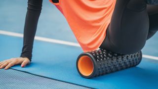 Close up of athlete foam rolling their glutes