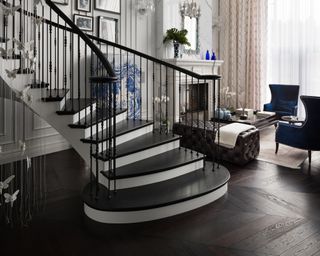 Monochrome stairs with black and white paint design and blue chairs