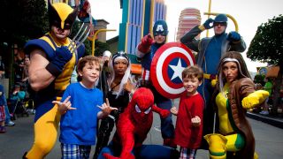 Kids posing with Marvel heroes at Marvel Super Hero Island.
