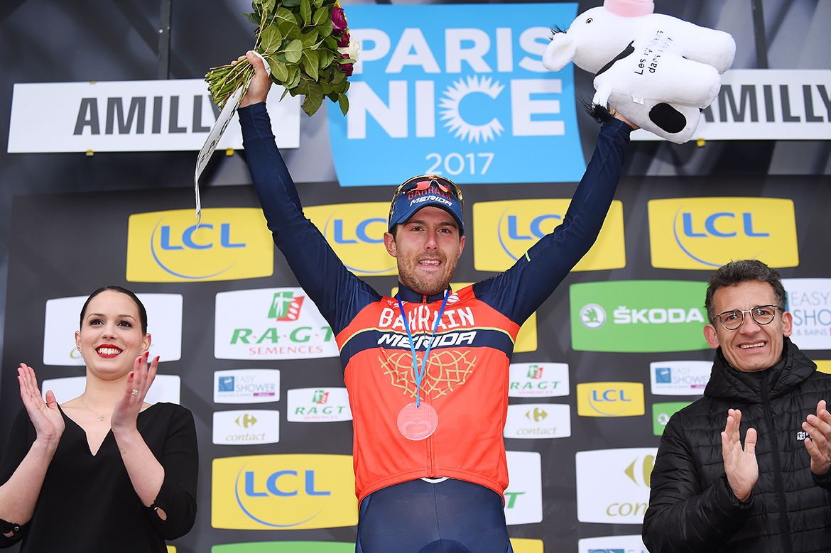 Sonny Colbrelli steps onto the podium after his win
