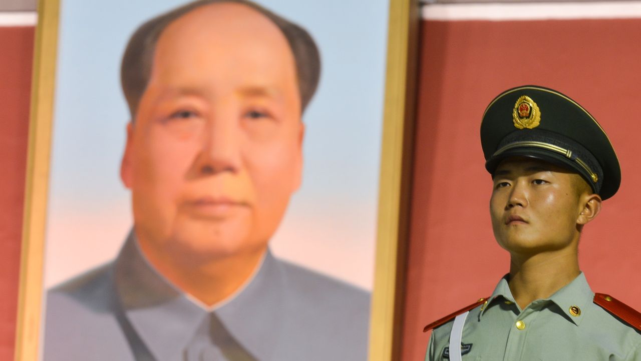 A military guard in front of Mao Zedong portrait at Tiananmen Monument, 2017