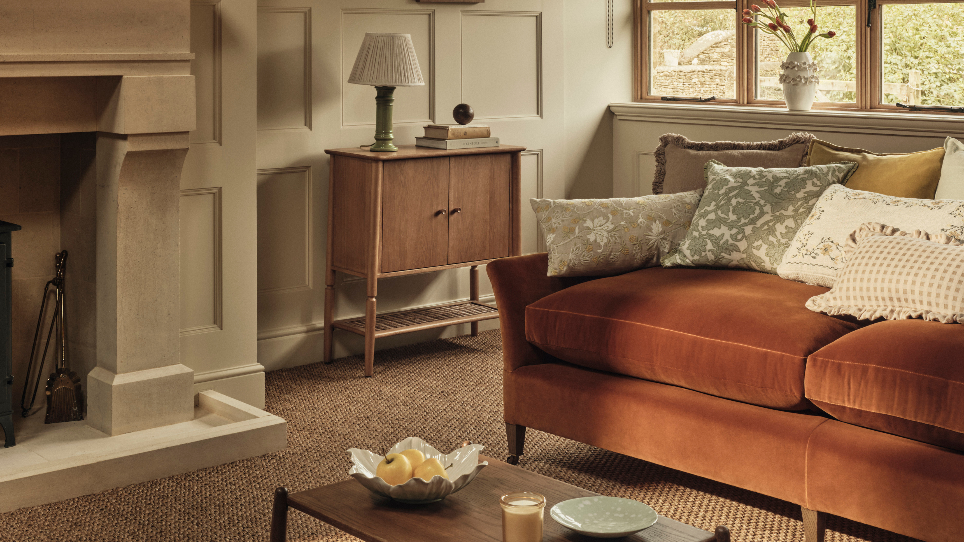 Orange sofa in warm, cosy living room.