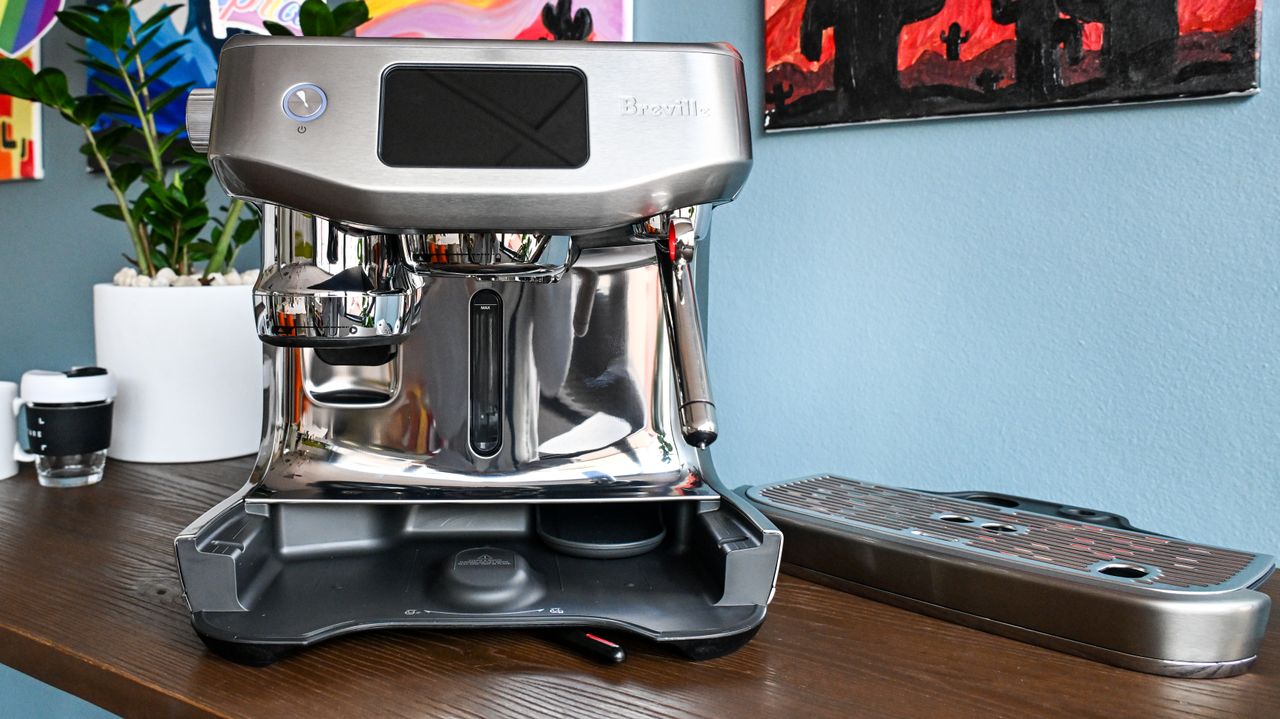 A front-on image of the Breville Oracle Jet coffee machine with its drip tray removed and sitting to one side.