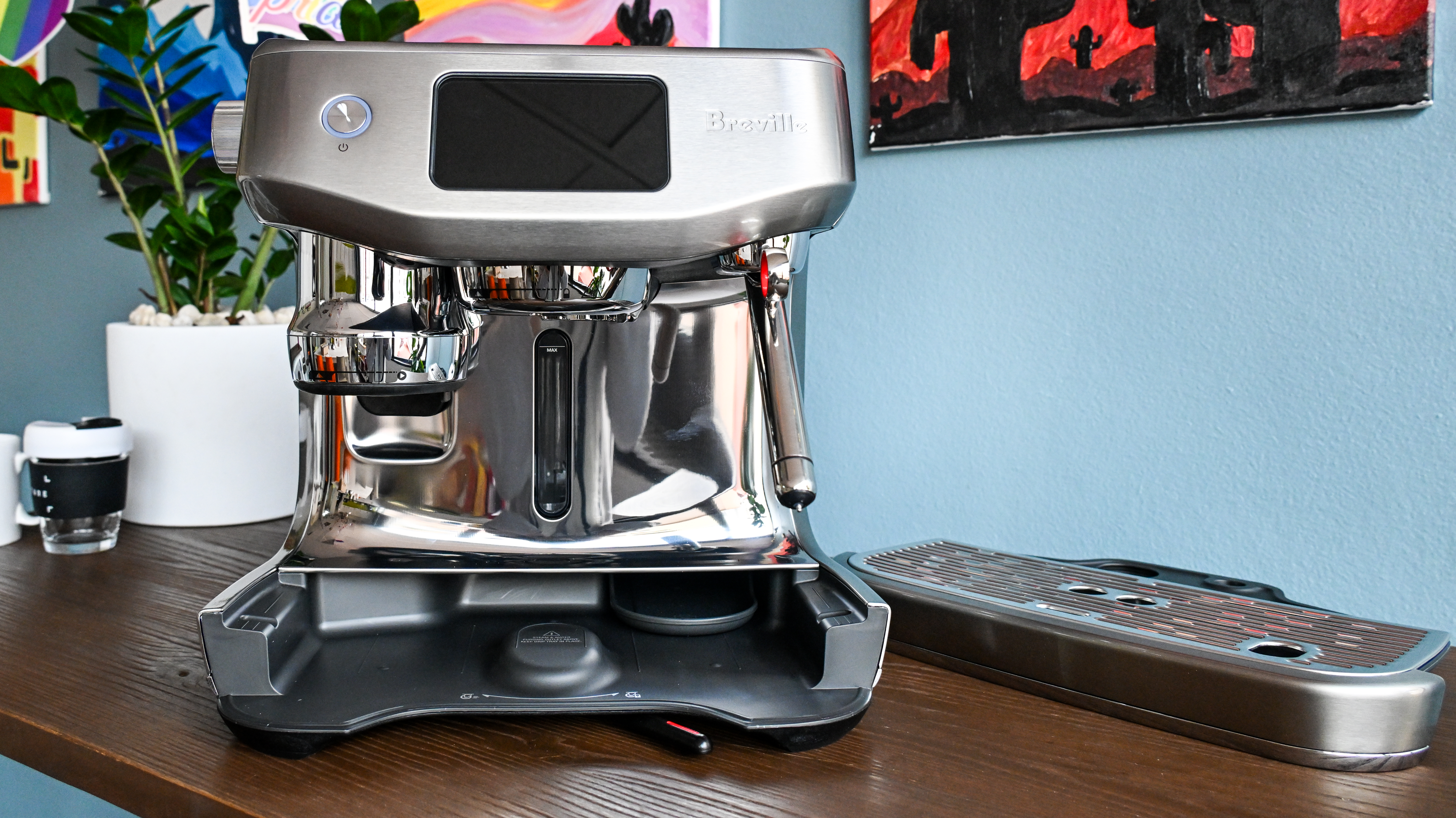 A front-on image of the Breville Oracle Jet coffee machine with its drip tray removed and sitting to one side.