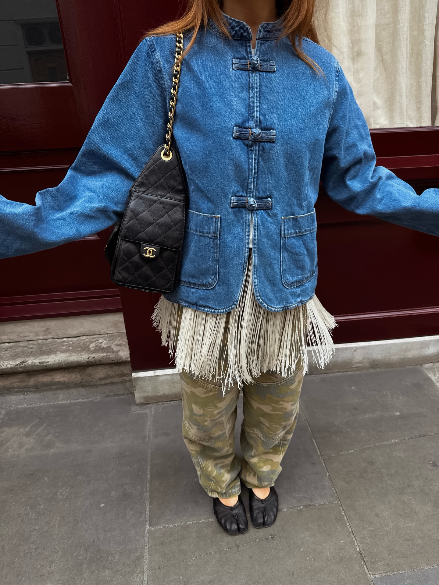 A woman wearing a camo-pant outfit in 2026.