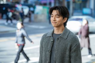 Gong Yoo as Han Jeong-won in The Trunk smiling while standing on the sidewalk