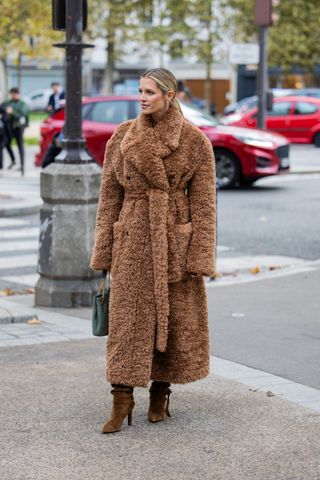 woman wearing belted teddy coat and boots