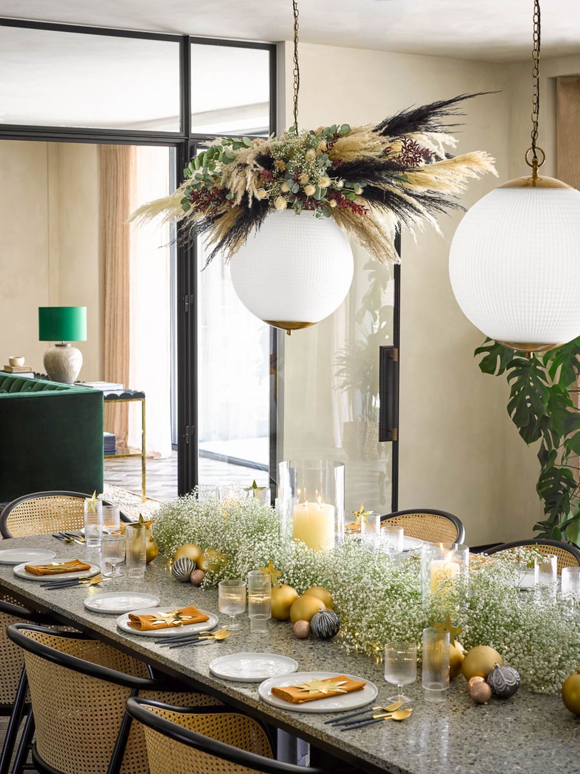 a christmas table with foliage around a light