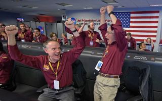 Kris Bruvold, left, and Sandy Krasner react after receiving confirmation that the Mars InSight lander successfully touched down on the surface of Mars