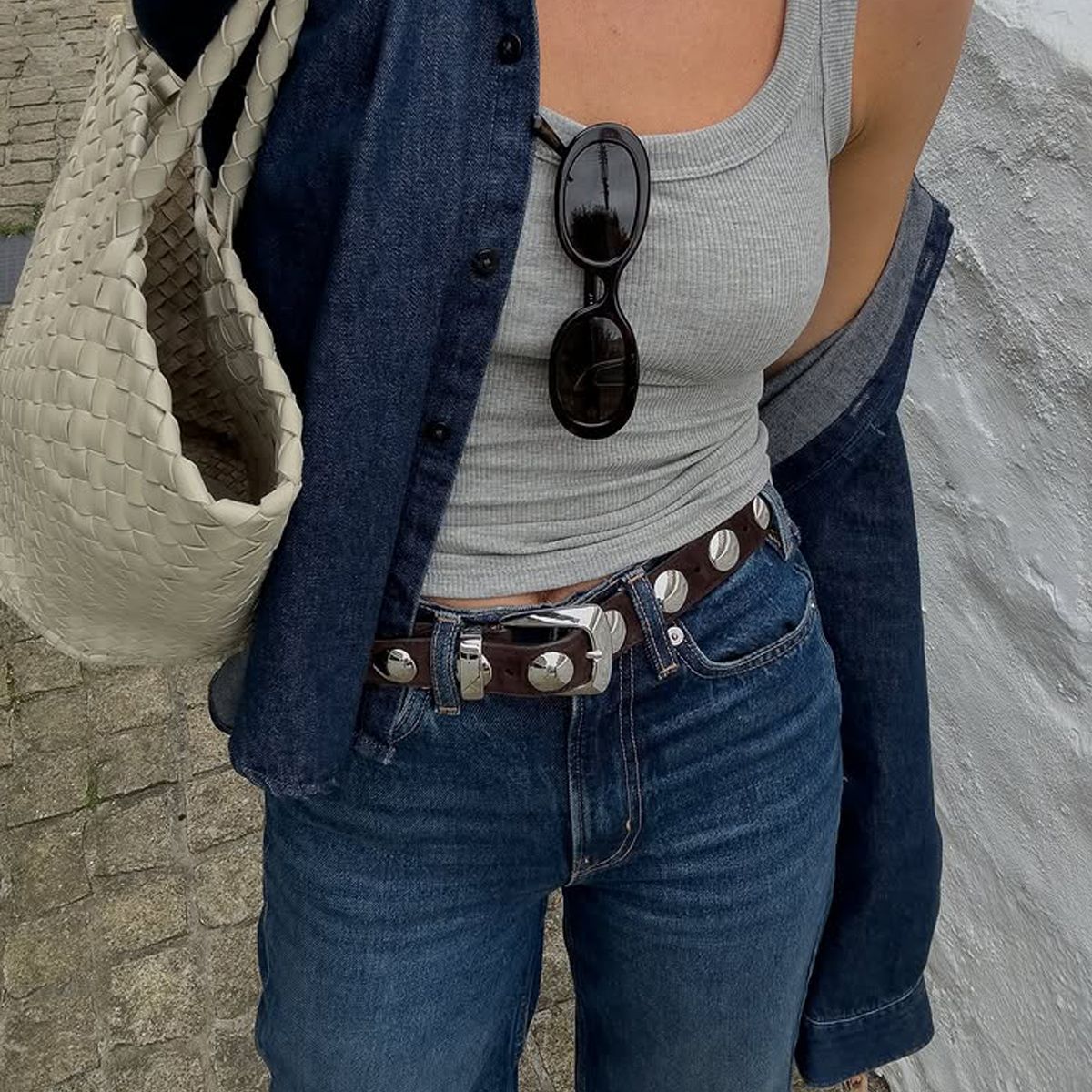 @_jessicaskye wears a pair of Agolde jeans with a studded belt