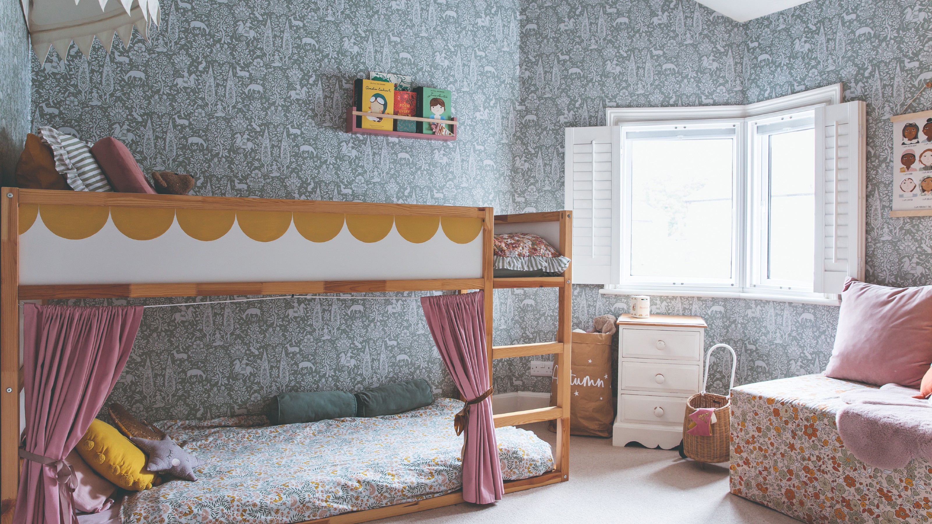 A children's bedroom with a bunk bed and Morris & Co wallpaper on the walls