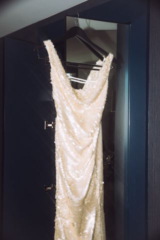 Marissa Bode's gold sequin dress for the Wicked premiere on a hanger