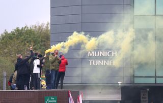 Manchester United fans let of yellow and green flares at Old Trafford