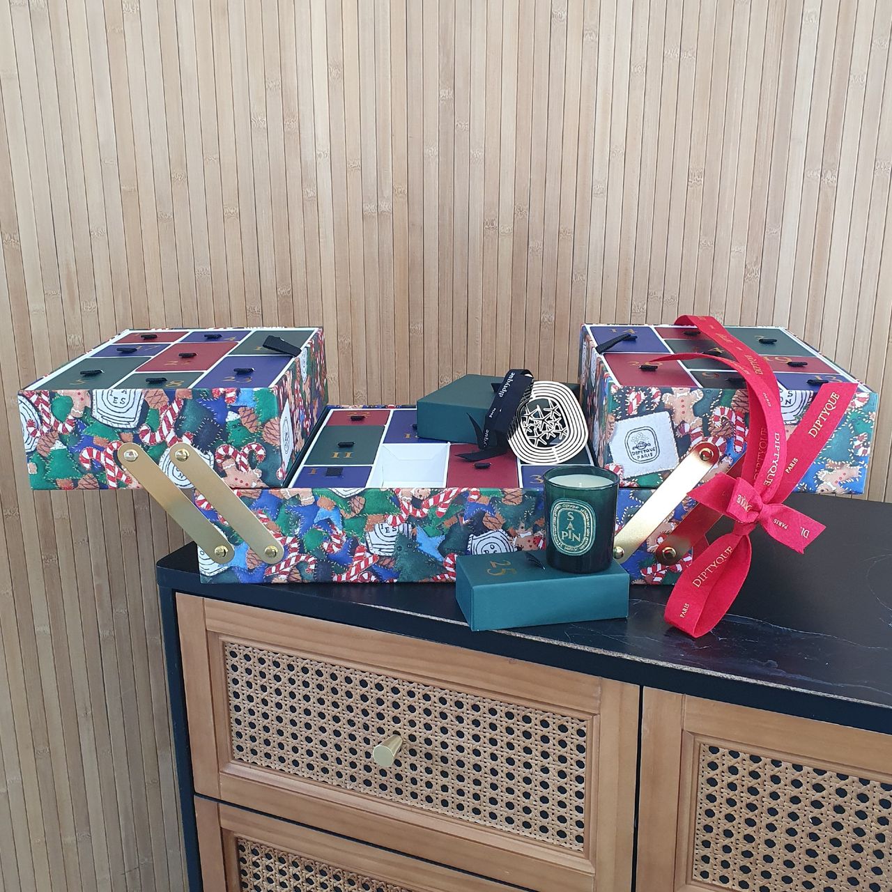 Diptyque advent calendar 2024 against a wood-panelled background