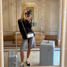 Lilly Sisto wears a Rimowa bag