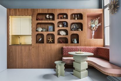 modern banquette with modern green dining table and built in shelving