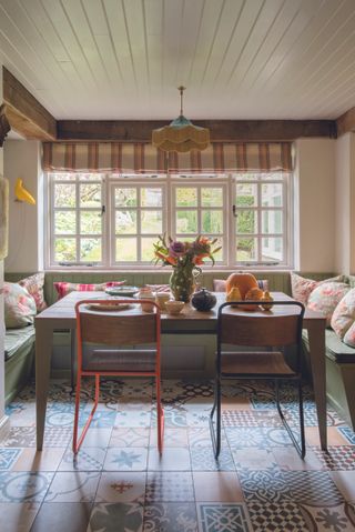 banquette seating around a country kitchen dining table