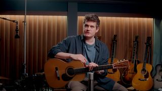 A still of John Mayer in the studio with a Martin 000 acoustic guitar