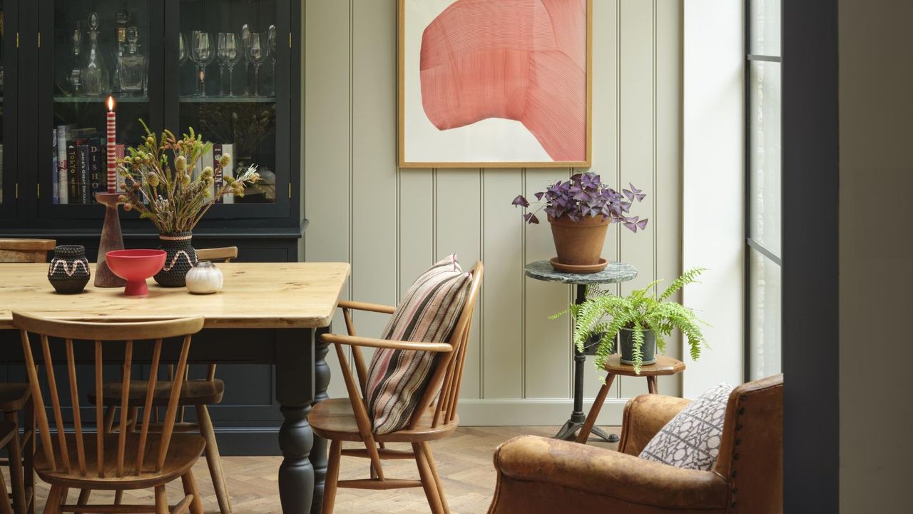  dining room with light green panelled wall, wooden dining table and chairs