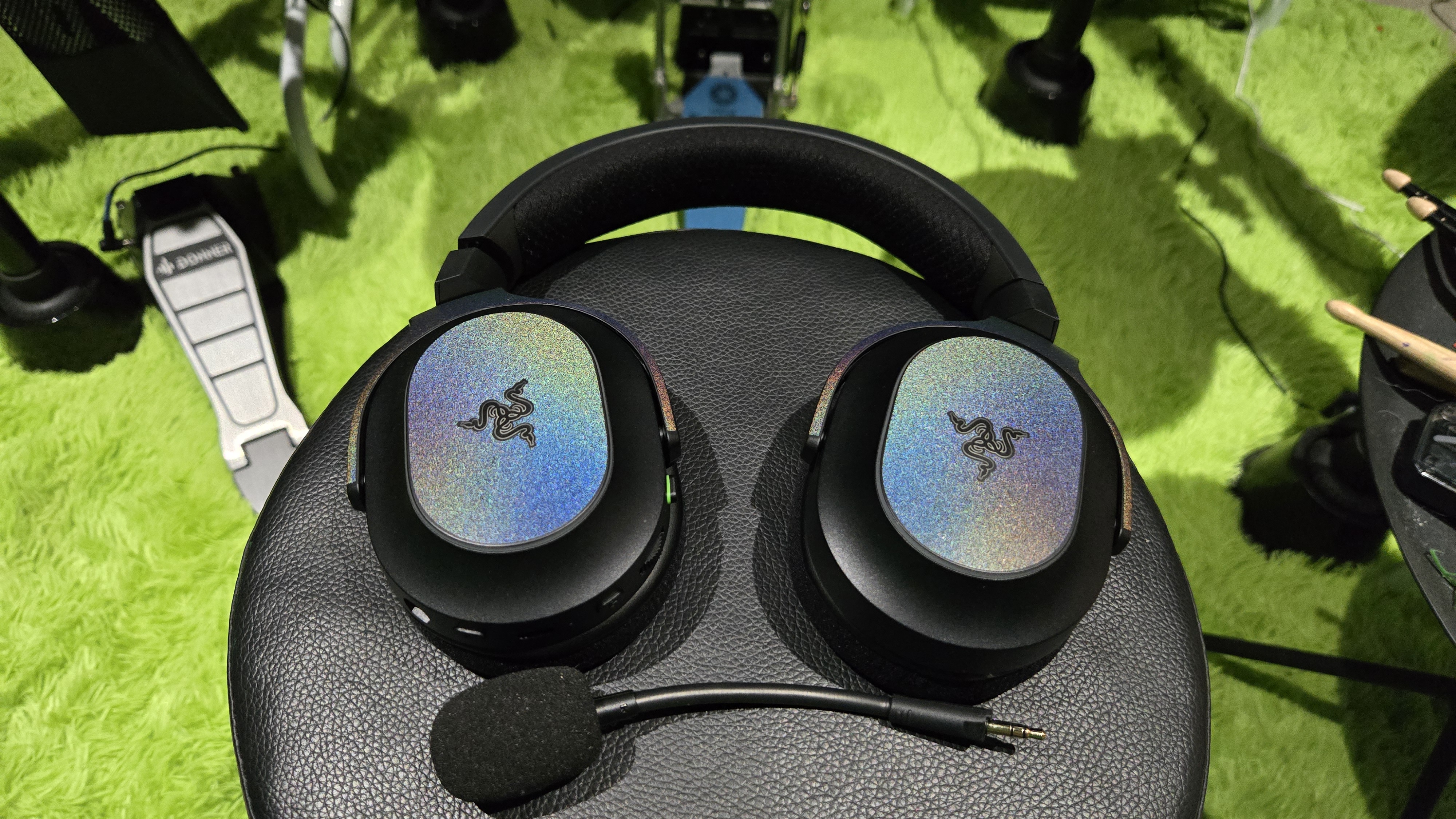 The Razer Barracuda X Chroma wireless gaming headset with a colorful finish on a chair.