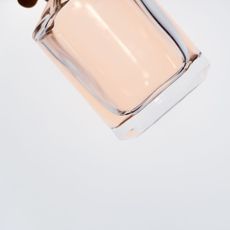 Black Friday Perfume Deals: A bottle of pink perfume floating in white space