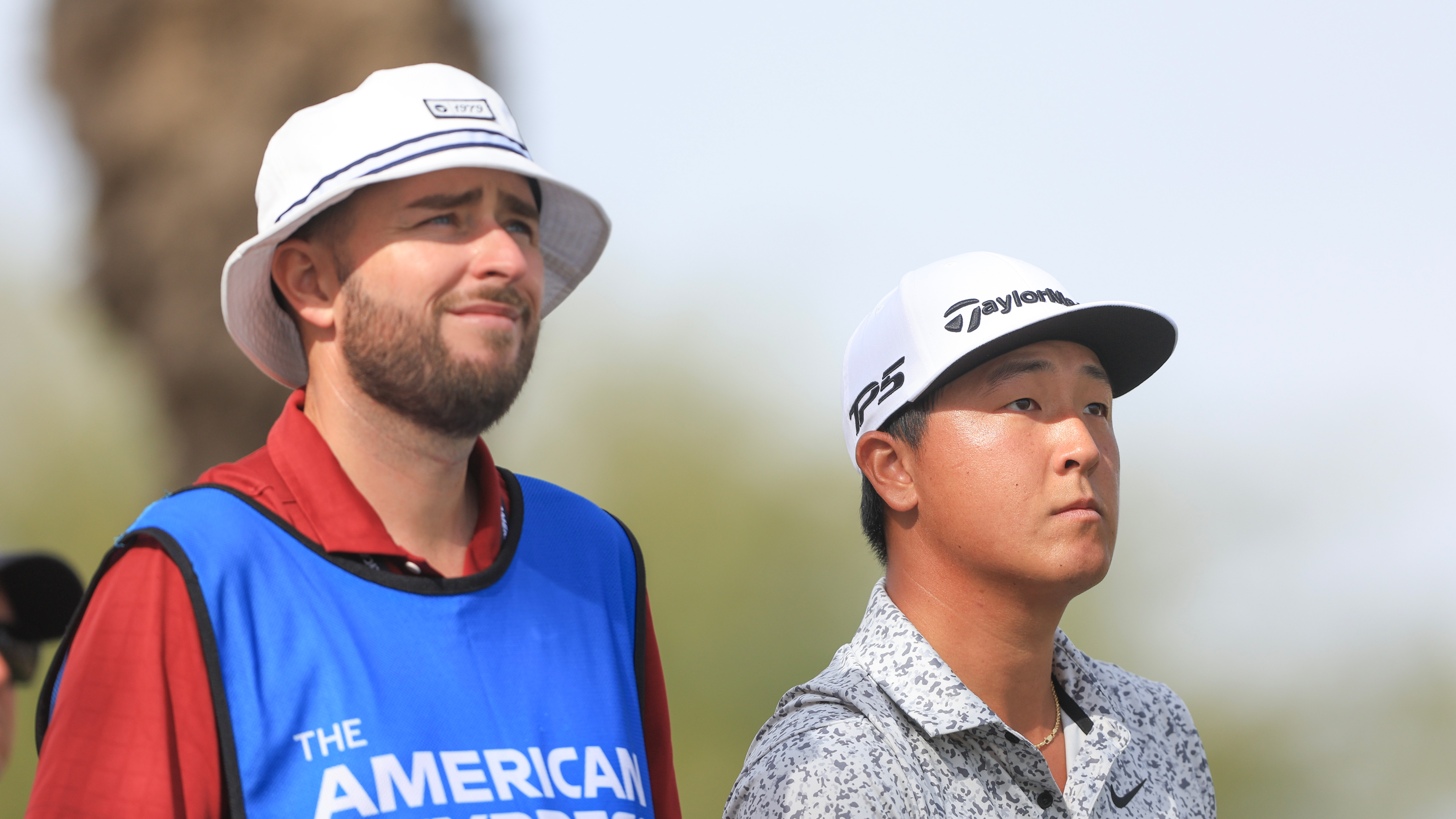 John Pak (right) and his caddie, Billy Narut look on during the 2025 American Express