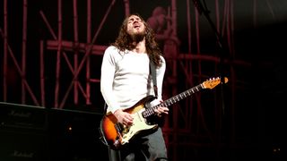 John FRUSCIANTE and RED HOT CHILI PEPPERS, John Frusciante performing live onstage, playing Fender Stratocaster guitar