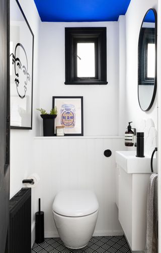 small white bathroom with blue painted ceiling by Interior Fox