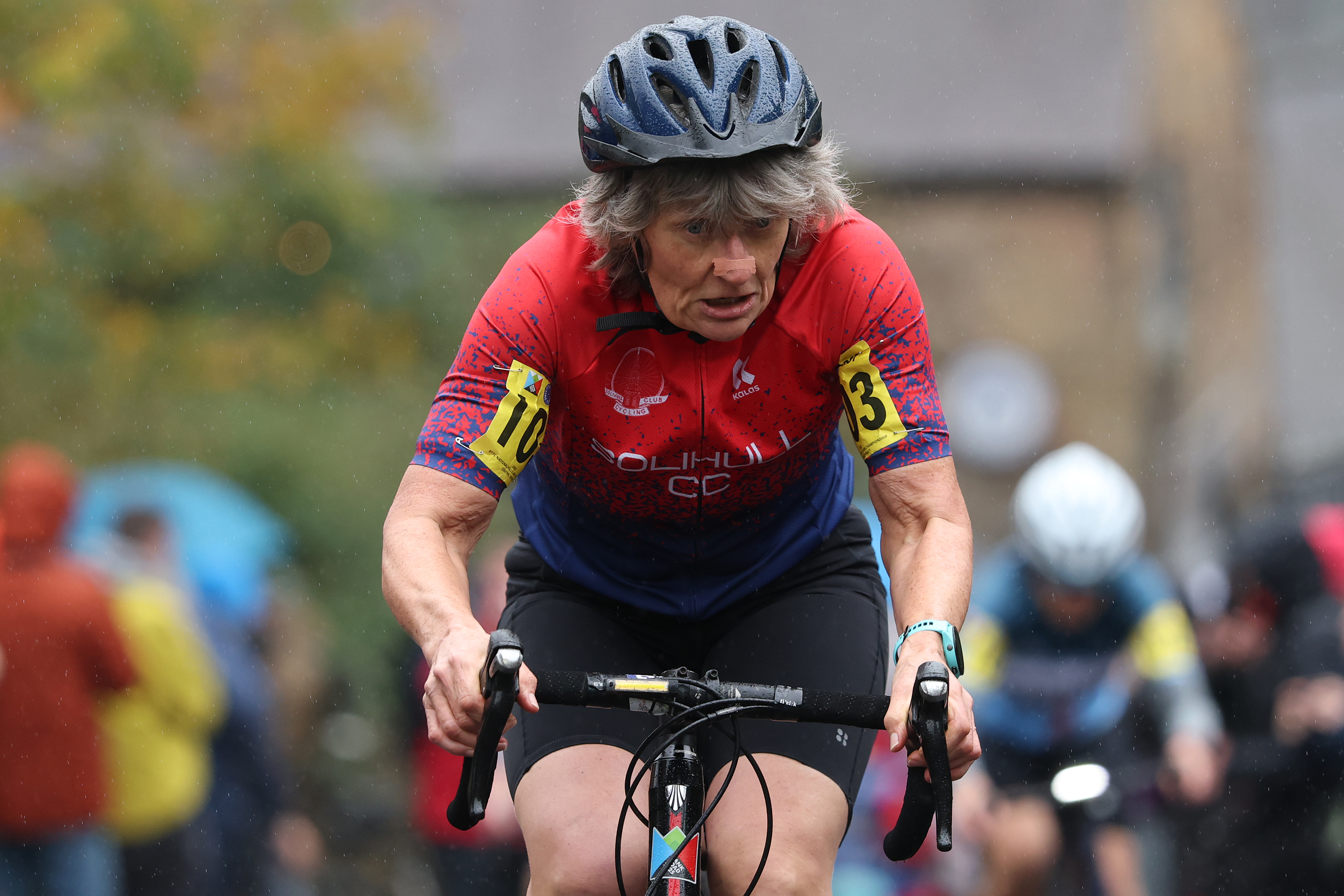 Woman cycles up hill