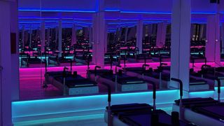 A fitness center, lit in in dark blue and purple hue, gets complete control from ADI | Snap One. 