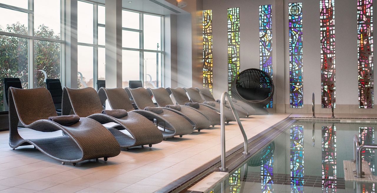 An indoor swimming pool and a row of beds