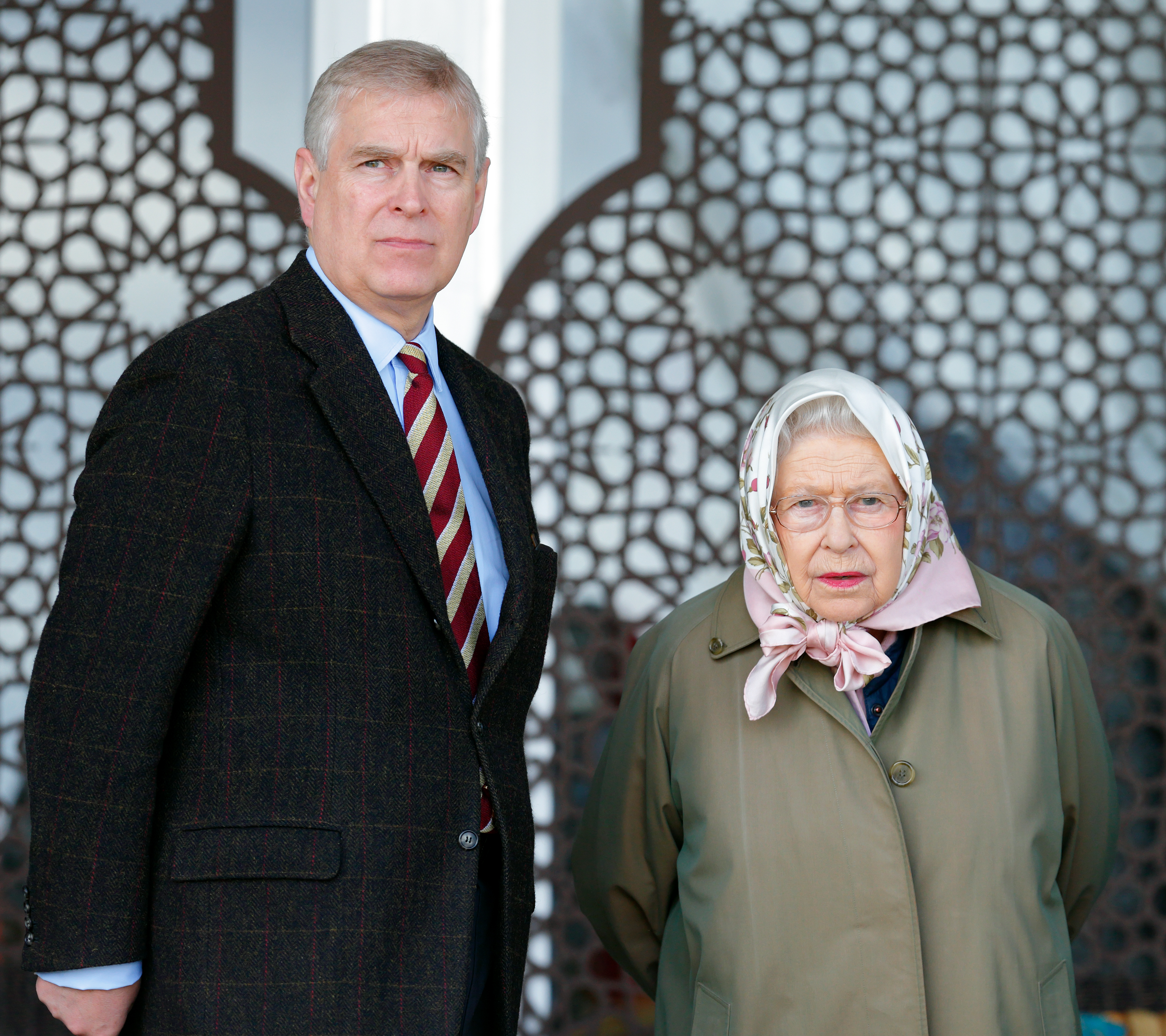 Andrew Mountbatten-Windsor standing next to Queen Elizabeth, wearing a scarf tied around her head