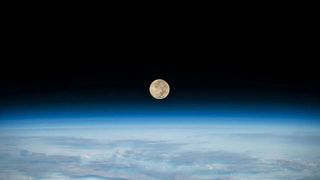 The full moon as seen from the International Space Station on Dec. 8, 2022. The moon is setting below Earth’s horizon as the station flew 269 miles above the southern Indian Ocean.