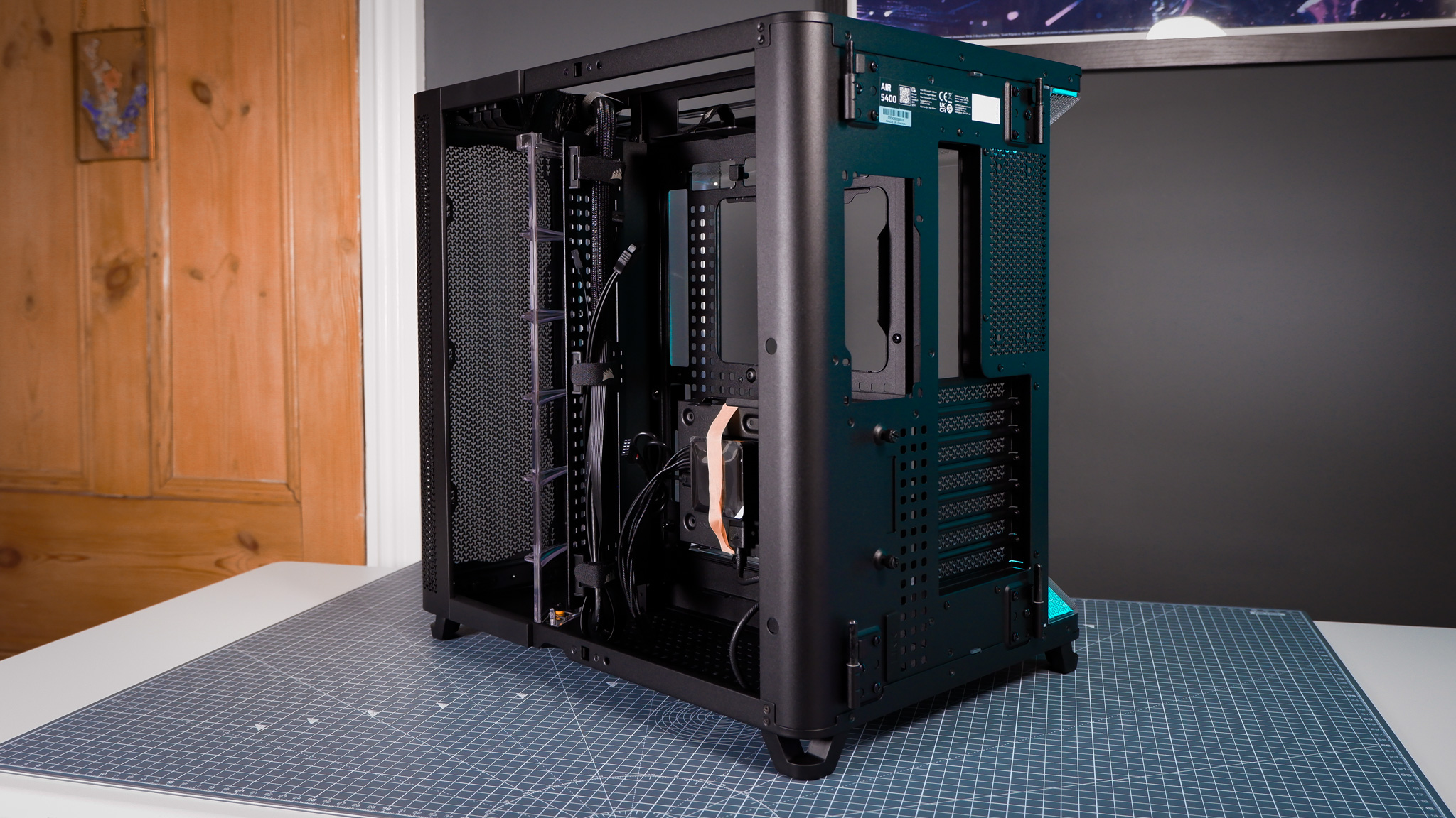 A Corsair Air 5400 PC case on a desk with various parts installed.
