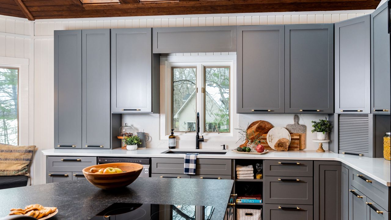 Kortney Wilson&#039;s modern kitchen with blue cabinets and quartz countertops