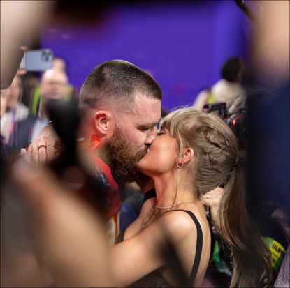 ravis Kelce #87 of the Kansas City Chiefs celebrates and kisses Singer Taylor Swift following the NFL Super Bowl 58.