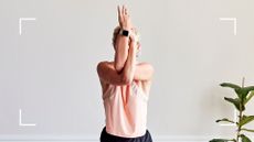 Woman stretching up into yoga pose, wearing fitness tracker on wrist, representing a factor in the decision between a Fitbit or Apple Watch