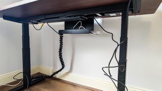 A black Cable Tray under the EverDesk Max table top
